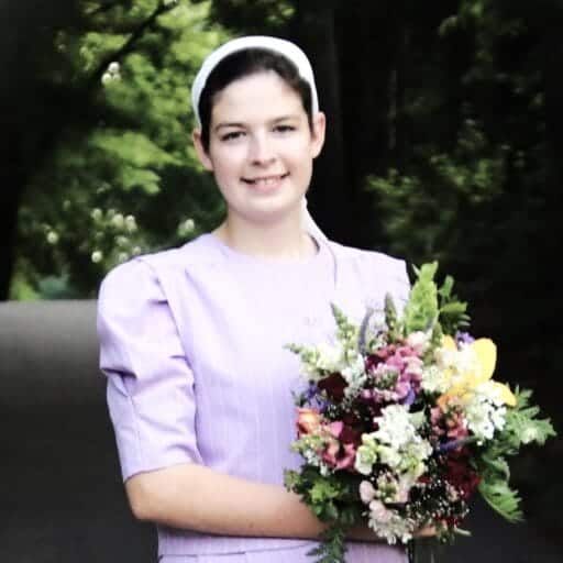 A fresh farm bouquet held by one of the sisters
